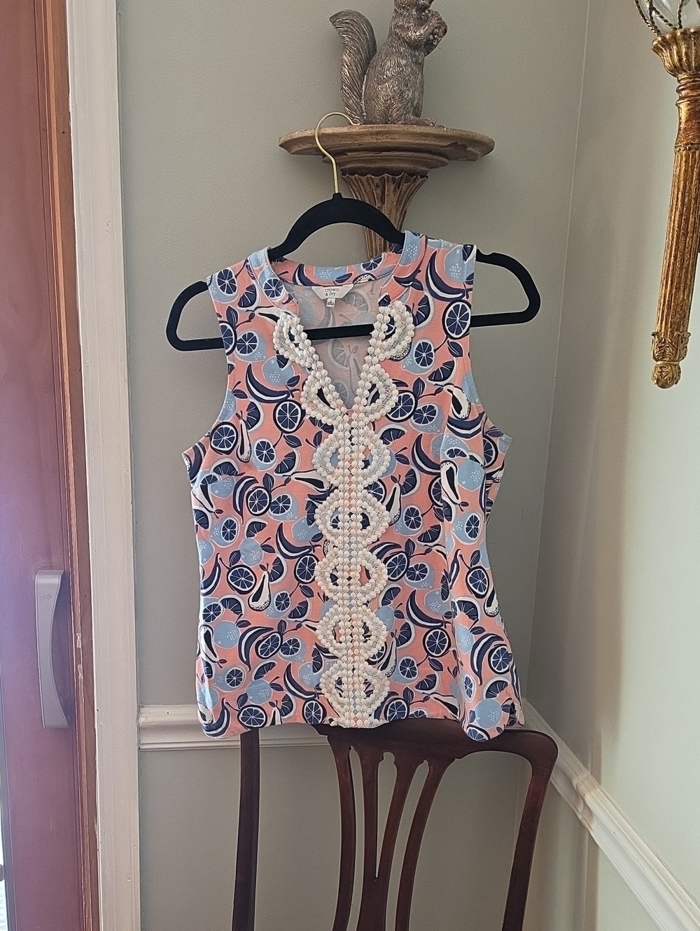 Crown & Ivy sleeveless V-neck knit top featuring a vibrant pink, blue, and orang